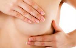woman-examining-her-breast-isolated-on-white